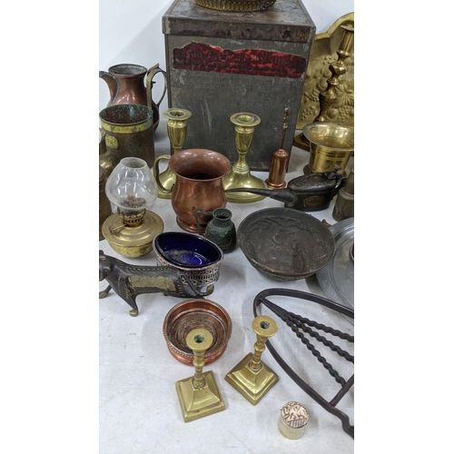 95 - A mixed lot of metalware to include brass candlesticks, a copper jug, a Spanish pewter tray and othe... 