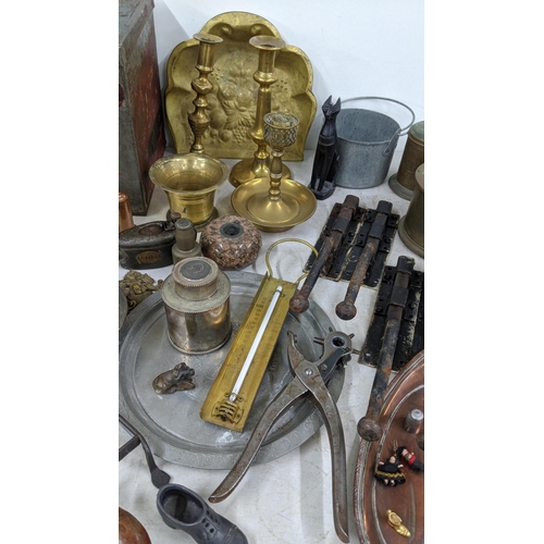 95 - A mixed lot of metalware to include brass candlesticks, a copper jug, a Spanish pewter tray and othe... 