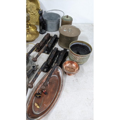 95 - A mixed lot of metalware to include brass candlesticks, a copper jug, a Spanish pewter tray and othe... 