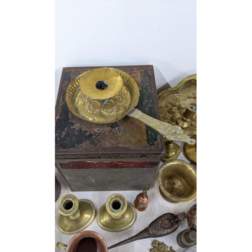 95 - A mixed lot of metalware to include brass candlesticks, a copper jug, a Spanish pewter tray and othe... 