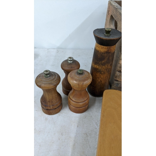 96 - A mixed lot to include various wooden chopping boards, treen pepper grinders, and other treen items
... 