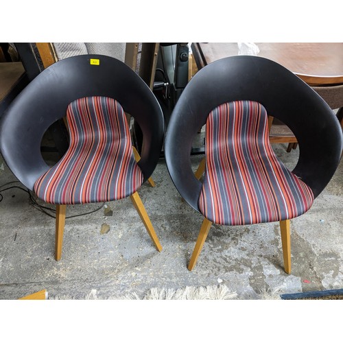 190 - A set of four Swedish design Skandiform dining chairs with striped upholstered seats, and square tap... 