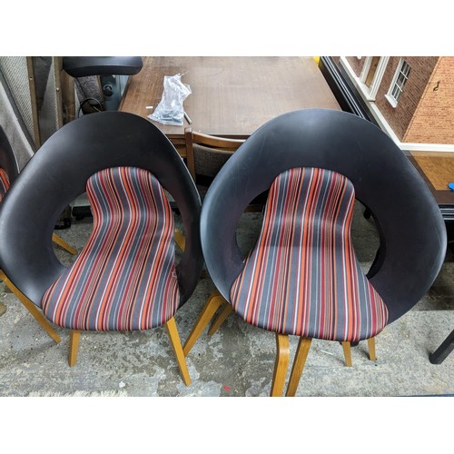 190 - A set of four Swedish design Skandiform dining chairs with striped upholstered seats, and square tap... 