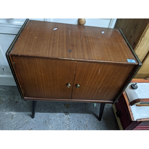 286 - A 1970s teak record cabinet with ebonized and inset brass strung sides, on splayed ebonized legs, ca... 