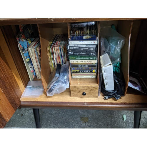 286 - A 1970s teak record cabinet with ebonized and inset brass strung sides, on splayed ebonized legs, ca... 