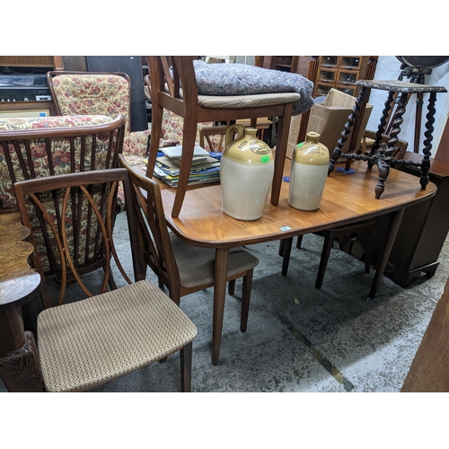 294 - A 1970s G-Plan teak extending dining table 73cm x 143cm (unextended) x 99cm, and a matching set of s... 