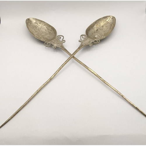 434 - A pair of South American white metal Quchua 'TuPu' shawl pins, having engraved floral design, 42cm, ... 