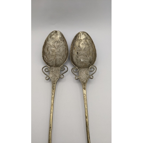 434 - A pair of South American white metal Quchua 'TuPu' shawl pins, having engraved floral design, 42cm, ... 