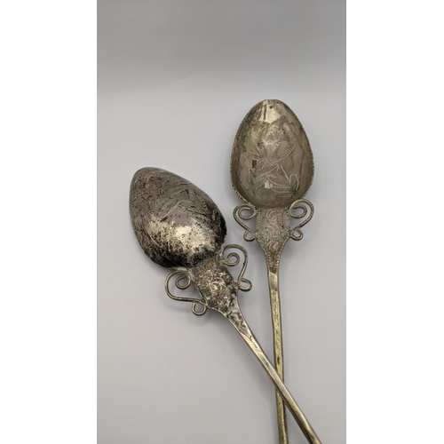 434 - A pair of South American white metal Quchua 'TuPu' shawl pins, having engraved floral design, 42cm, ... 