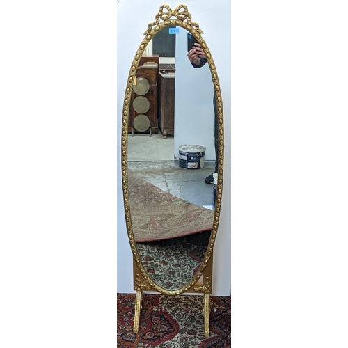 273 - A French style oval gold painted cheval mirror, the frame with egg and dart decoration, surmounted w... 