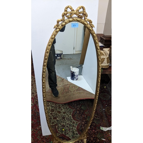 273 - A French style oval gold painted cheval mirror, the frame with egg and dart decoration, surmounted w... 