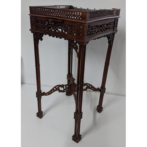 299 - A late 19th/early 20th century mahogany kettle stand in the Chippendale style having pierced fretwor... 