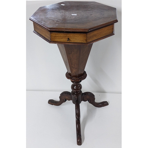 380 - A Victorian walnut sewing table having a hinged octagonal top with a fitted interior and tripod base... 