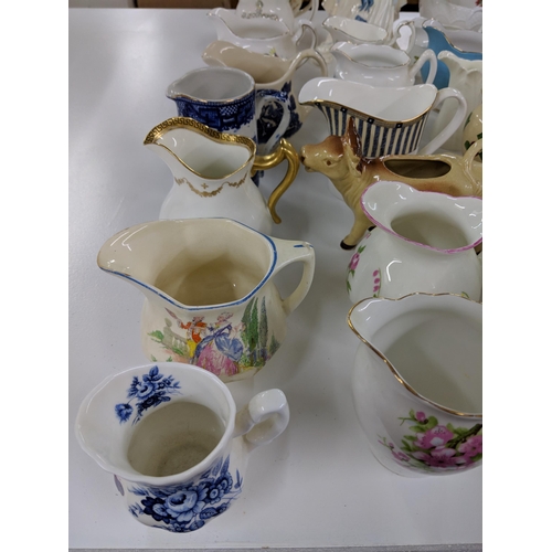 408 - A collection of approx. fifty milk and cream jugs to include Aynsley, Royal Albert and Aynsley Cotta... 