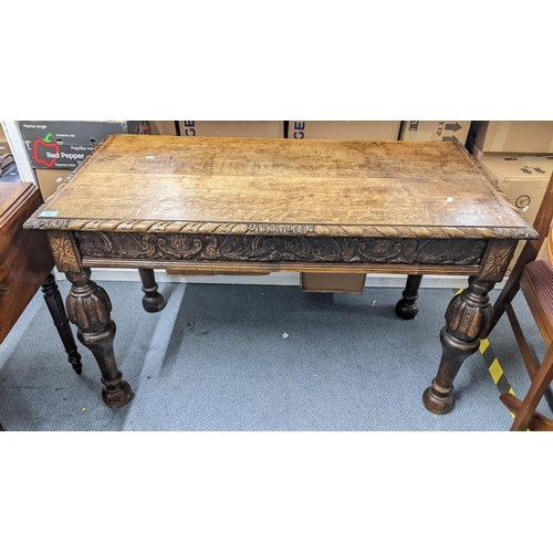 419 - A late 19th/early 20th century oak two drawer side table in the 17th century style, having a carved ... 