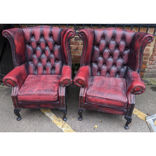 431 - A pair of reproduction red leather Chesterfield wingback armchairs
Location:FOYER