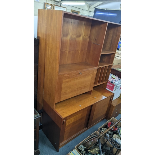 459 - A pair of mid 20th century Domino Mobler teak bookcases with sliding doors below, 183h x 122.5w
Loca... 