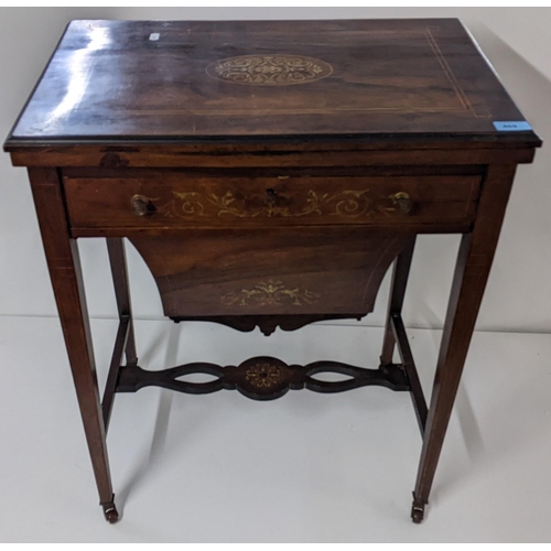 469 - An Edwardian rosewood combination games and work table having a fold over top and marquetry inlaid, ... 