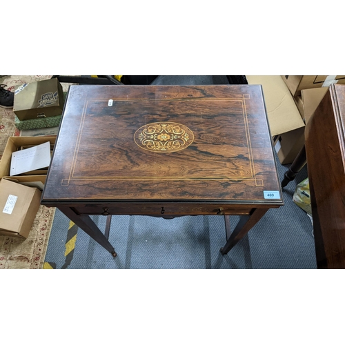 469 - An Edwardian rosewood combination games and work table having a fold over top and marquetry inlaid, ... 