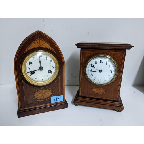 482 - Two Edwardian inlaid mahogany mantel clocks, the arched shaped clock striking on a gong Location:G (... 