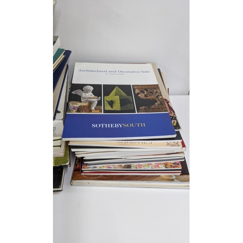 501 - A collection of auction catalogues including Sotherby's and Christies together with various hard bac... 