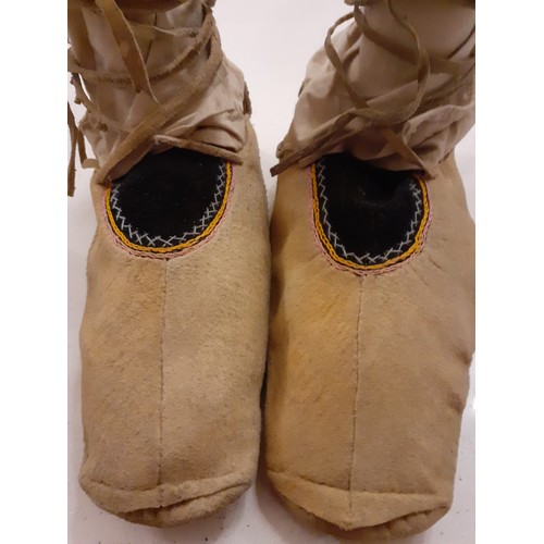 130 - A pair of North American native Indian leather moccasins 27cm long with embroidered detail together ... 