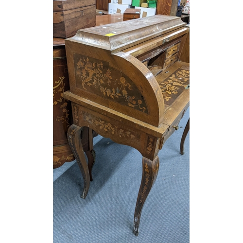 198 - A mid 20th century Dutch style roll top bureau having floral marquetry inlaid, fitted interior above... 