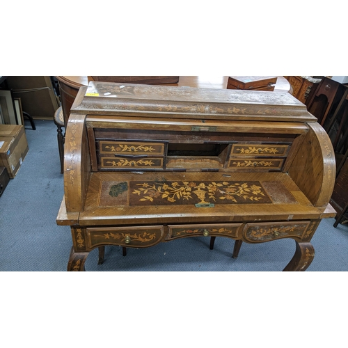 198 - A mid 20th century Dutch style roll top bureau having floral marquetry inlaid, fitted interior above... 