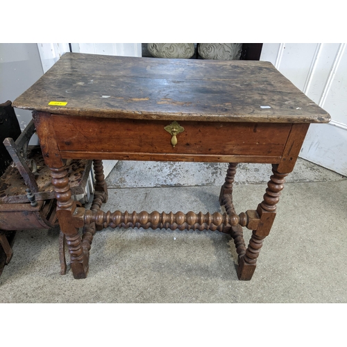 201 - A Georgian mixed wood lowboy, single drawer with brass handle, on bobbin turned and block legs and s... 