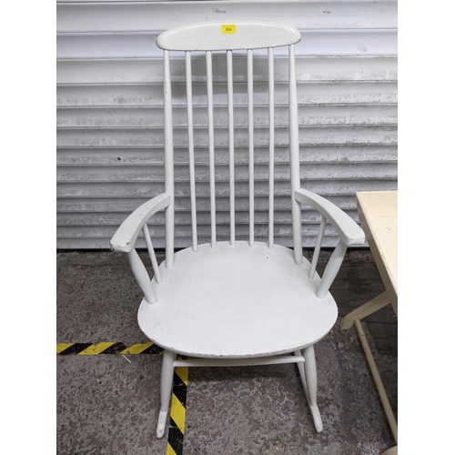 204 - A white painted mid-century rocking chair, cream painted butler's tray on folding stand, and pine ba... 