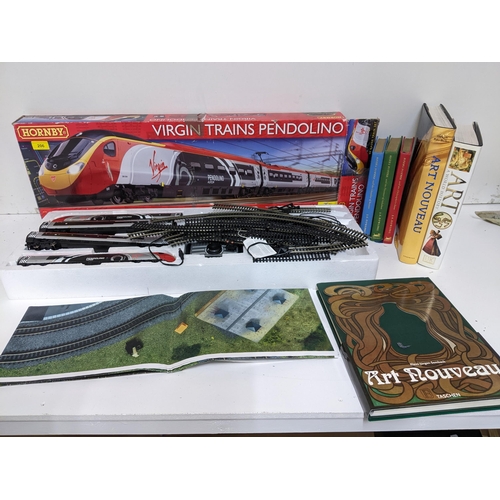 206 - A Hornby Virgin Trains Pendolino model railway, along with three Harry Potter books, two books of Ar... 