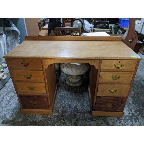 213 - Early 20th century light oak and pine kneehole desk, extended back, four graduated drawers to each p... 