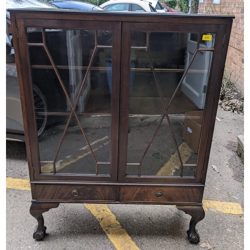 215 - A mahogany display cabinet with twin astragal doors, internal shelves, over two base drawers, on sho... 