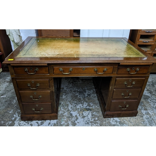 217 - An early 20th century mahogany twin pedestal writing desk the top with inset green tooled leather to... 