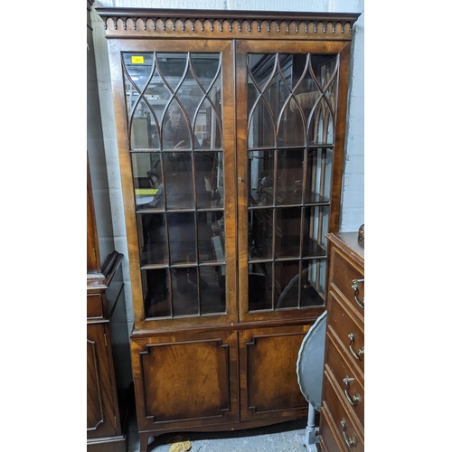 221 - A reproduction mahogany display cabinet, twin astragal glazed doors and sides, internal shelves, twi... 