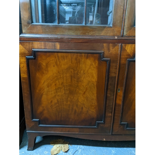 221 - A reproduction mahogany display cabinet, twin astragal glazed doors and sides, internal shelves, twi... 