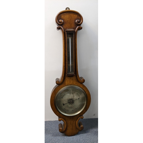 477 - A Victorian Negretti & Zambra wall hanging barometer, in an oak scroll carved case, silvered dial nu... 