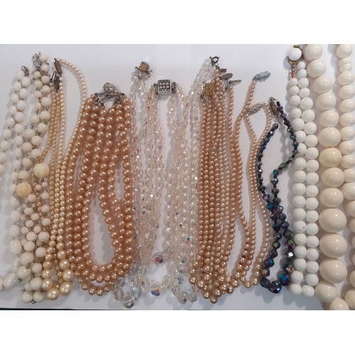 57 - A quantity of vintage costume jewellery to include 4 Aurora Borealis necklaces, simulated pearl neck... 