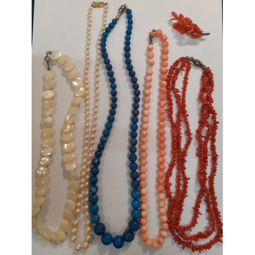 59 - A small quantity of vintage necklaces comprising Lapis Lazuli, coral to include one with a 9ct gold ... 