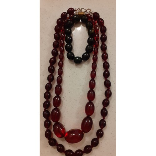 62 - Two Bakelite necklaces with red beads and one Bakelite bracelet with black beads. Location:R1.2