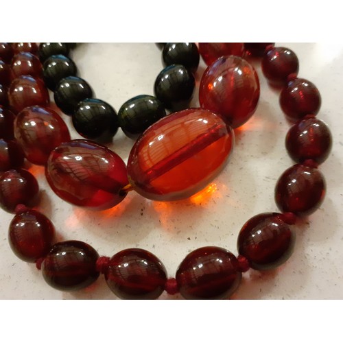 62 - Two Bakelite necklaces with red beads and one Bakelite bracelet with black beads. Location:R1.2