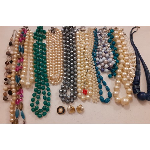 107 - A quantity of vintage bead necklaces to include a green glass bead necklace together with 3 clip on ... 