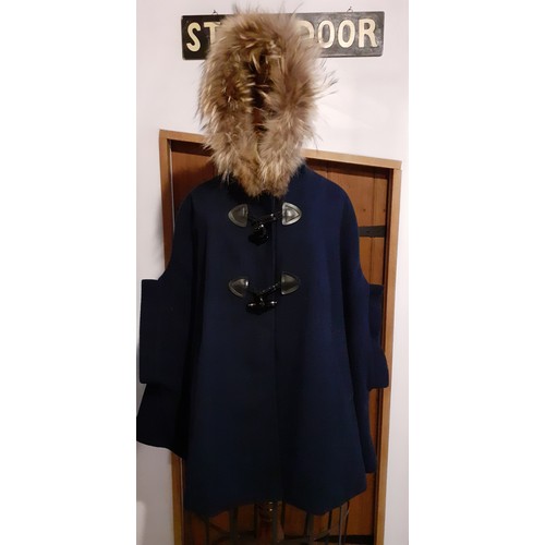 73 - A group of fur trimmed clothing and accessories comprising a Ruiyge navy cashmere mix cape with 2 du... 