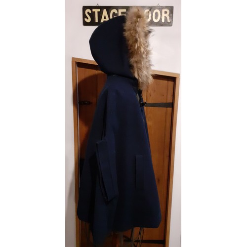 73 - A group of fur trimmed clothing and accessories comprising a Ruiyge navy cashmere mix cape with 2 du... 