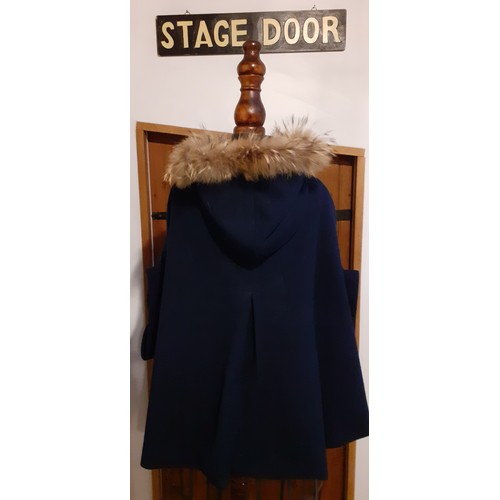 73 - A group of fur trimmed clothing and accessories comprising a Ruiyge navy cashmere mix cape with 2 du... 