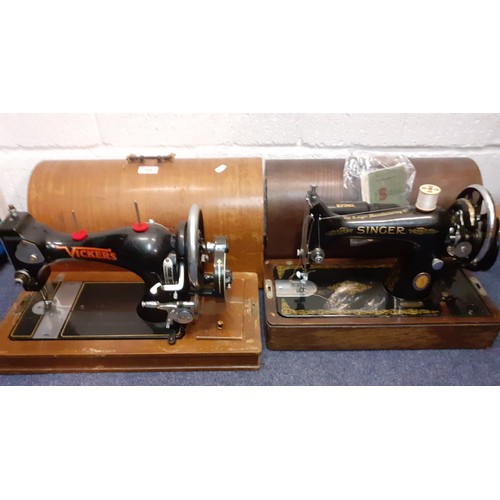 132 - Two vintage sewing machines comprising a Vickers machine Serial No:74832898 in an oak case with key,... 