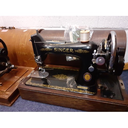 132 - Two vintage sewing machines comprising a Vickers machine Serial No:74832898 in an oak case with key,... 