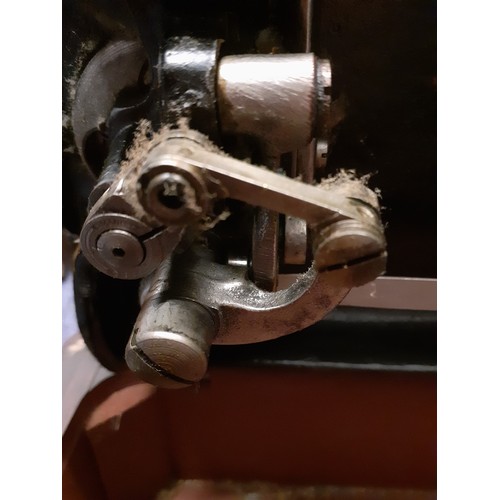 132 - Two vintage sewing machines comprising a Vickers machine Serial No:74832898 in an oak case with key,... 