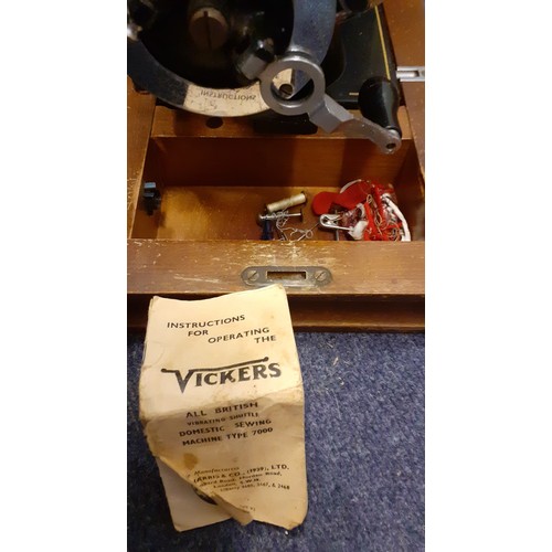 132 - Two vintage sewing machines comprising a Vickers machine Serial No:74832898 in an oak case with key,... 