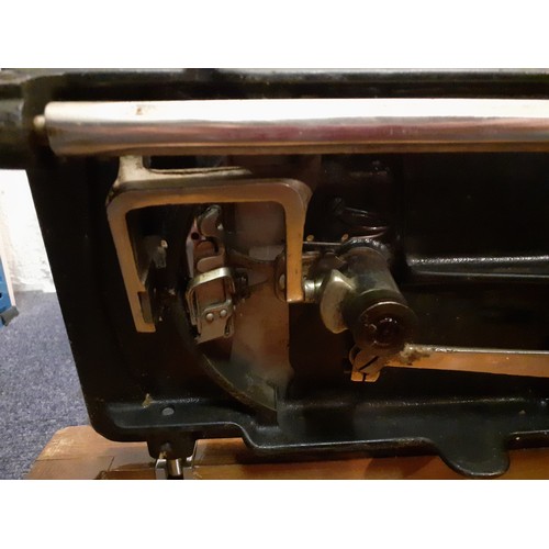 132 - Two vintage sewing machines comprising a Vickers machine Serial No:74832898 in an oak case with key,... 